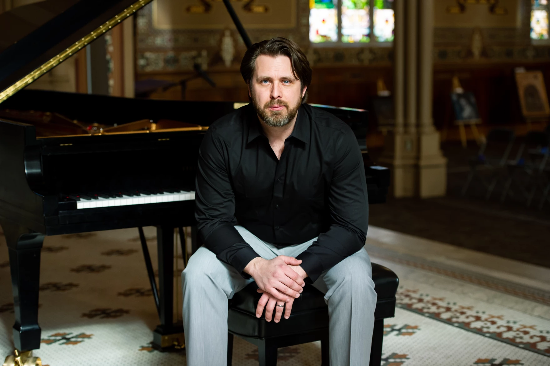 Andrzej Kozlowski sits at his piano. Photo Credit: Annie Farber.